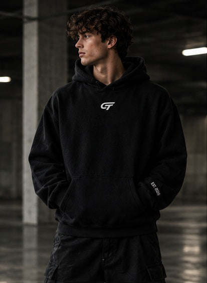 GRIPT FW26 Oversized Hoodie in black, worn by model, front view with GT chest logo