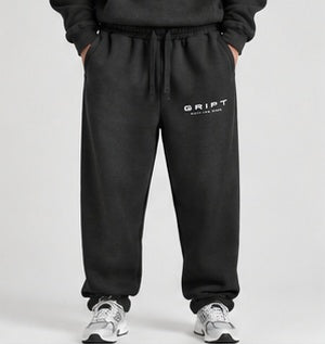 GRIPT FW26 Heavyweight Joggers in black on model, front view with GRIPT thigh logo